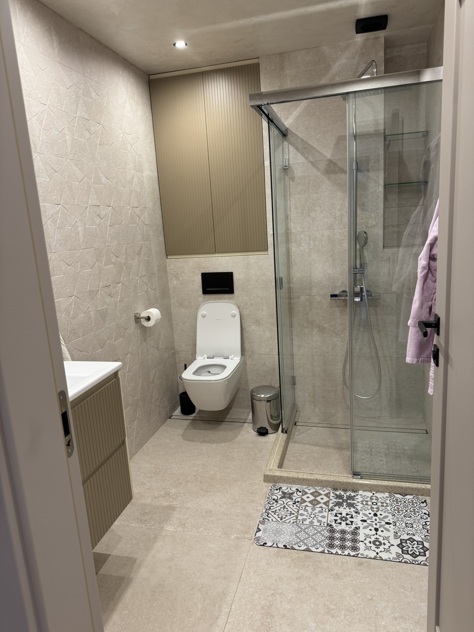 Bathroom with glass-enclosed shower in House 56